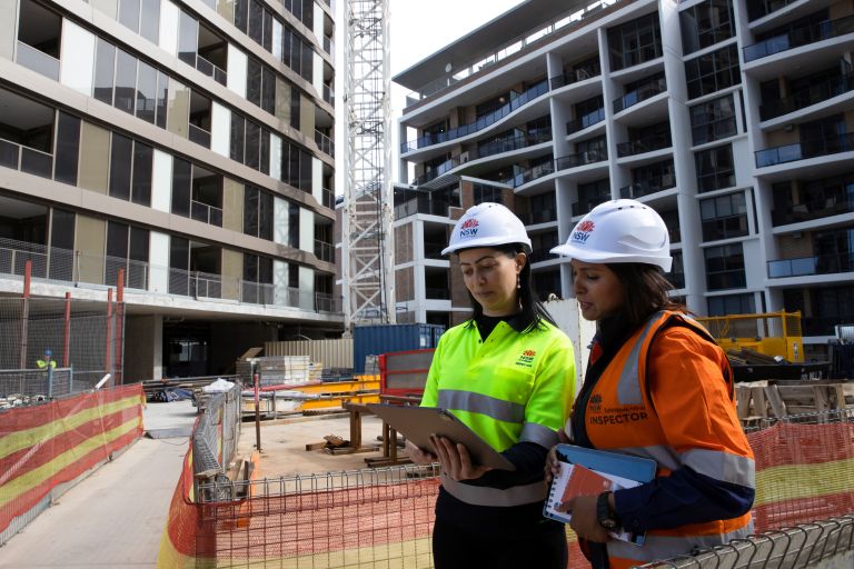 Two building inspectors on a construction site