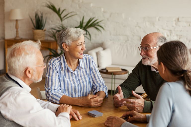 Neighbours sitting at table talking