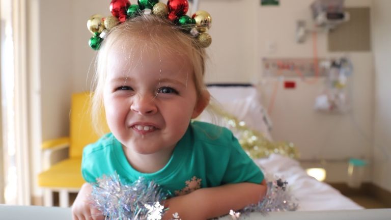 Sick little girl in hospital celebrating Christmas