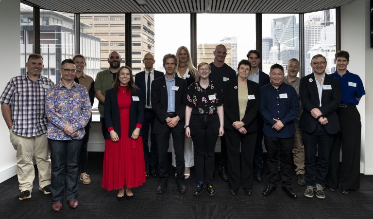 Group photo of the 16 members of the LGBTIQ+ Advisory Council