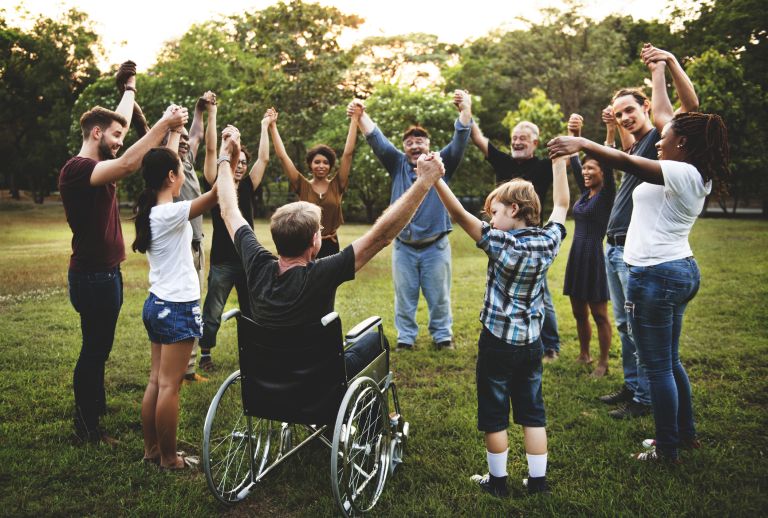 Group of friend in the park holding hands