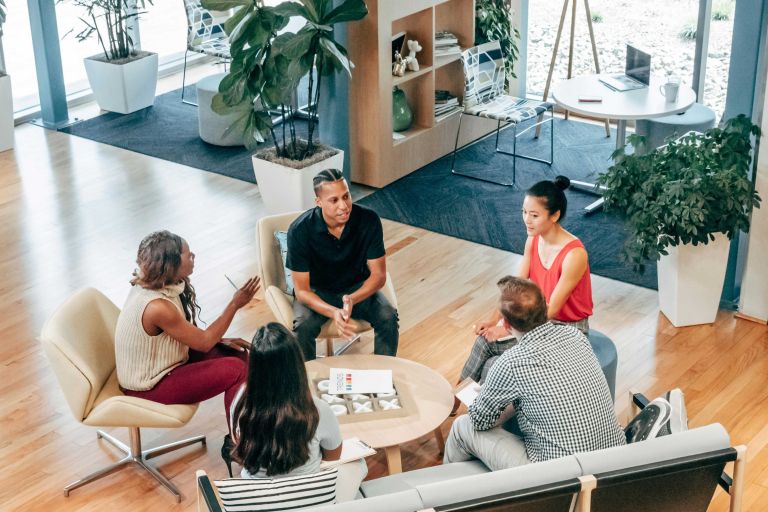 Group of workers sitting and having a conversation.