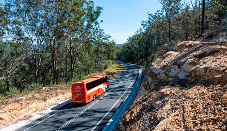 A trainlink coach going up a hill in a regional area