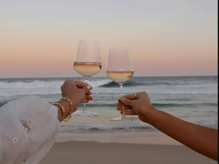 Wine glasses with beach in background