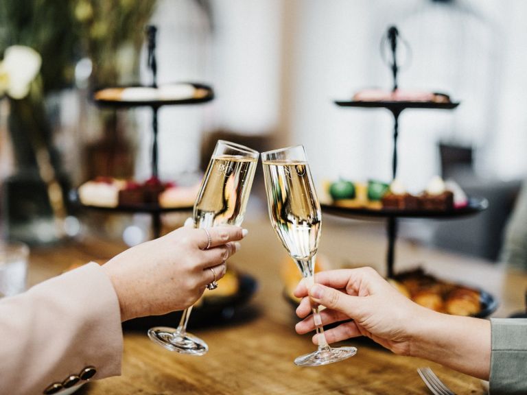 High tea set up at Ms Mary café Newcastle with sparkling wine cheers