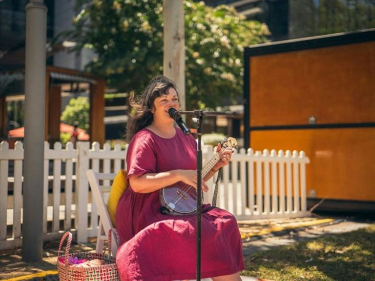 Lady singing and playing guitar