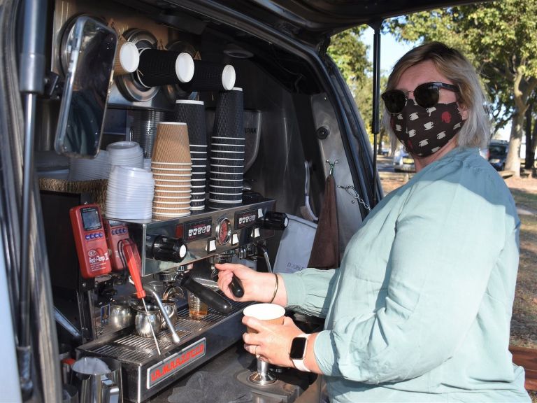 Lady at a coffee van making coffee