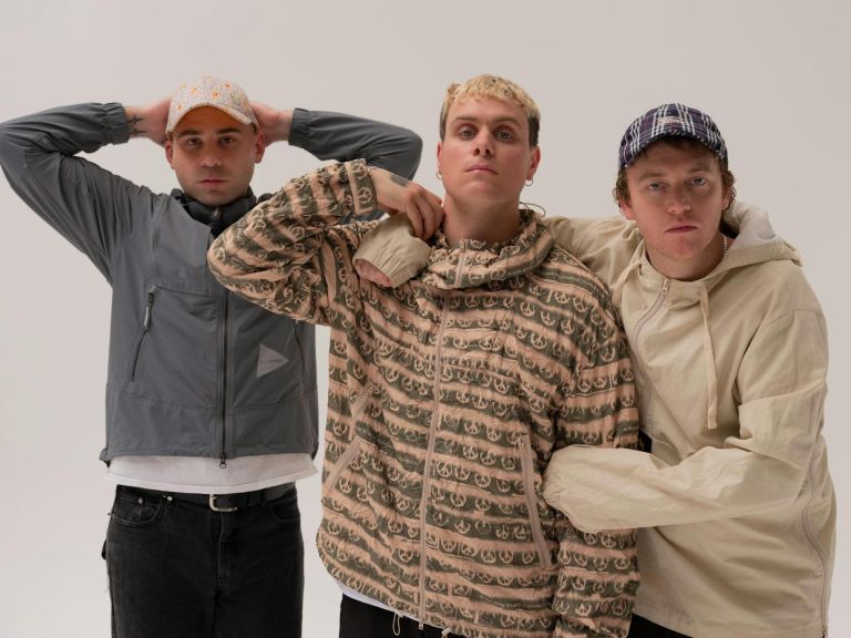 A funny shot of the three DMA'S band members on a blank background