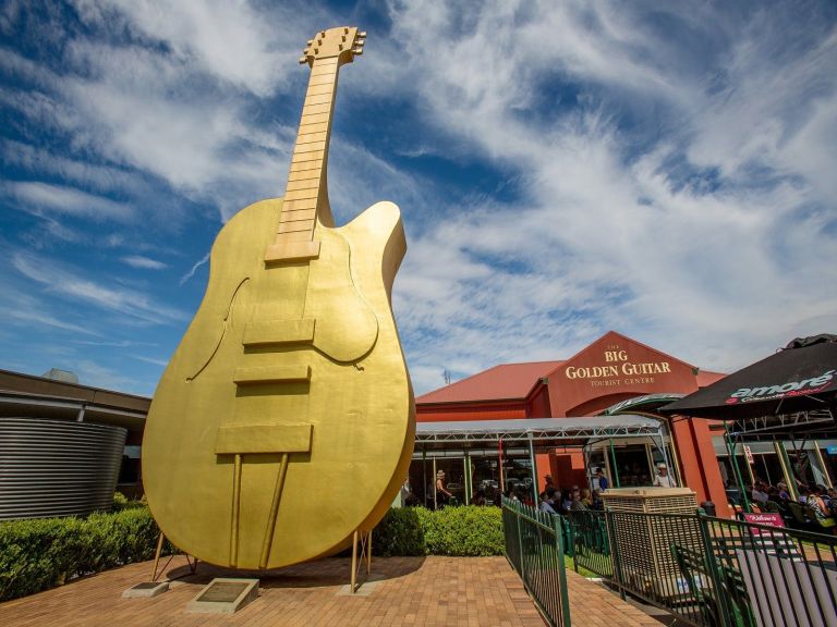 Photo of the Big Golden Guitar and Information Centre behind it