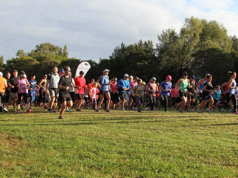 Group of runners with Parkrun banner