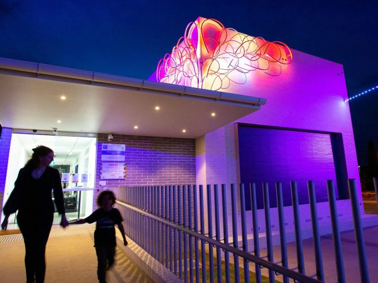 Outside view of the Multi-Arts Pavilion, mima lit up at nighttime