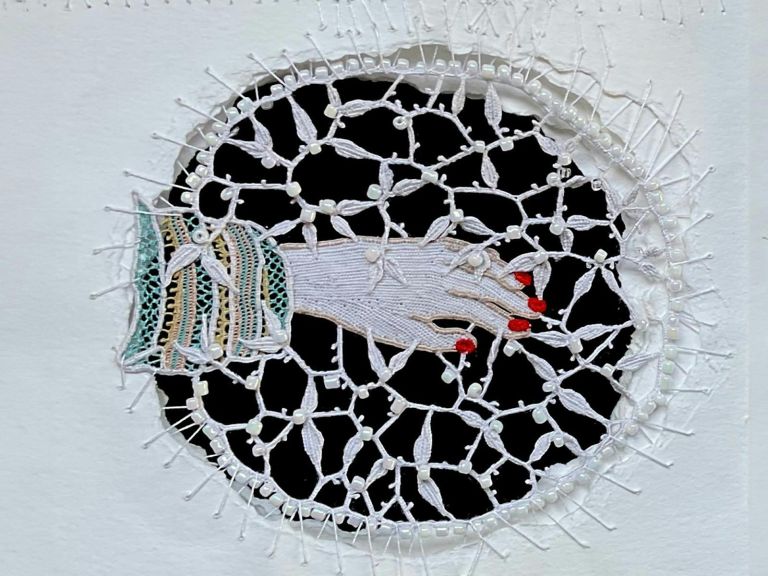 Needle lace depicting a hand with painted red nails