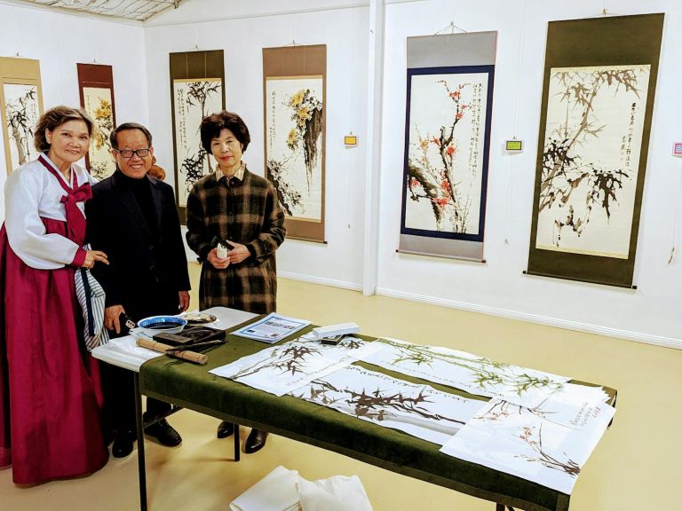 Artist Hyosoon Shin and other special Korean guests in Forever Young Gallery, displaying calligraphy