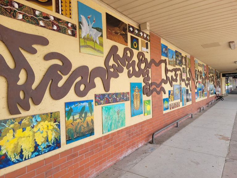 windy metal recreation of the murray river along a wall with individual art work from local students