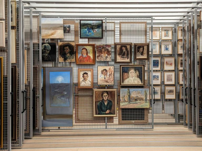 A collection of ten paintings from the Bundanon Collection hanging on a wire pull out rack