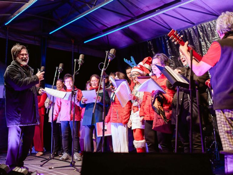 Carollers on stage in costume