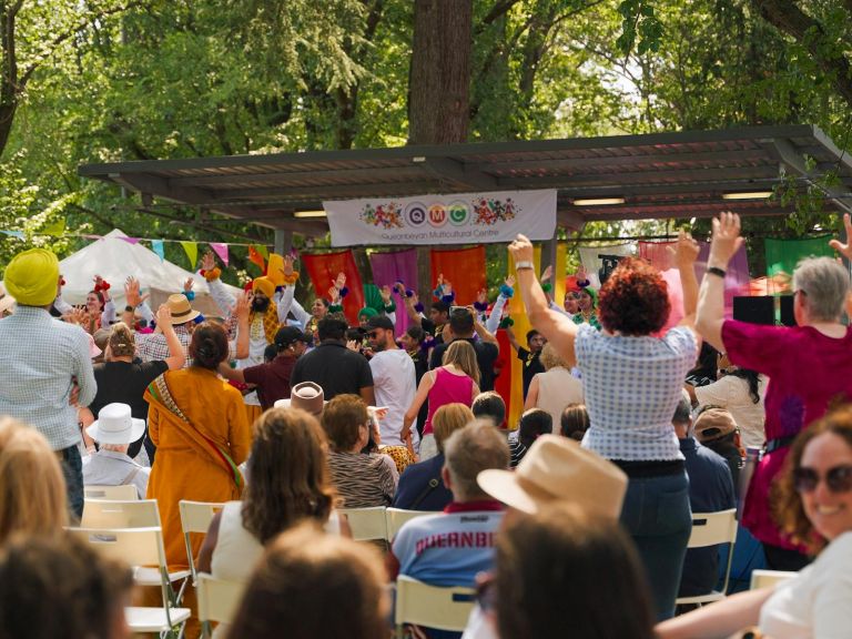 Audience celebrating in front of a busy stage