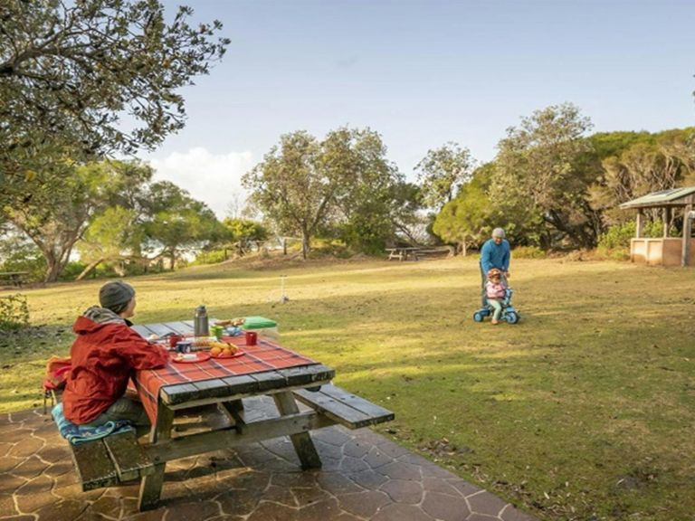 A family with a picnic at Haycock Point picnic area, Beowa National Park. Photo: John Spencer &copy;