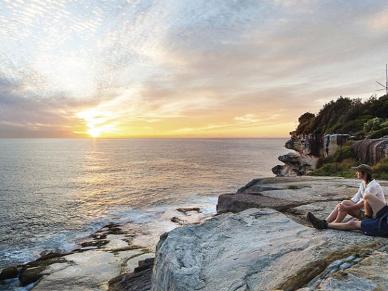 A couple enjoying the sunrise, Hornby Lighthouse at South Head, Sydney Harbour National Park. Photo: