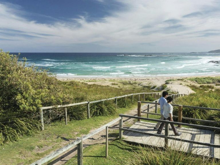 Couple enjoying views over Pretty Beach on the NSW South Coast. Photo credit: David Finnegan