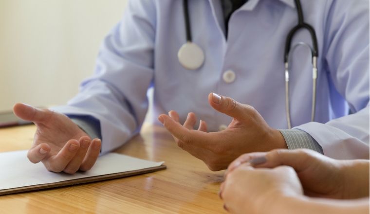 Medical doctor consulting female patient