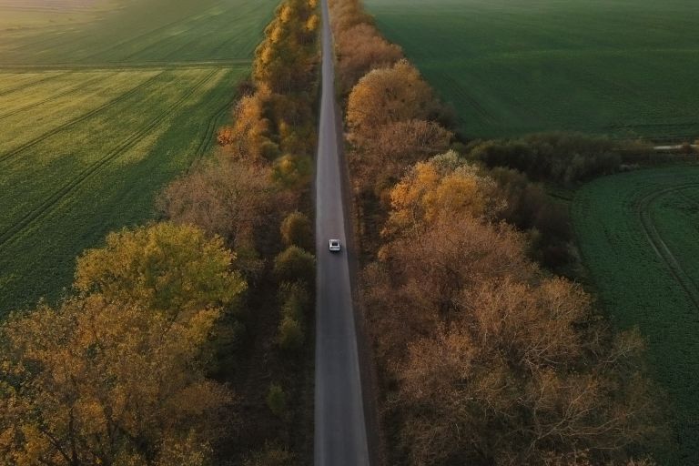 Aerial view Electric Car Driving on Country Road.