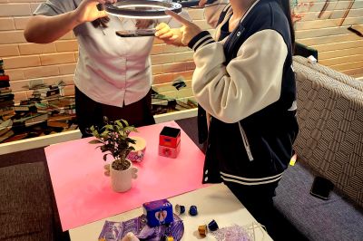 young people using props, camera and lighting to create a product advertisement